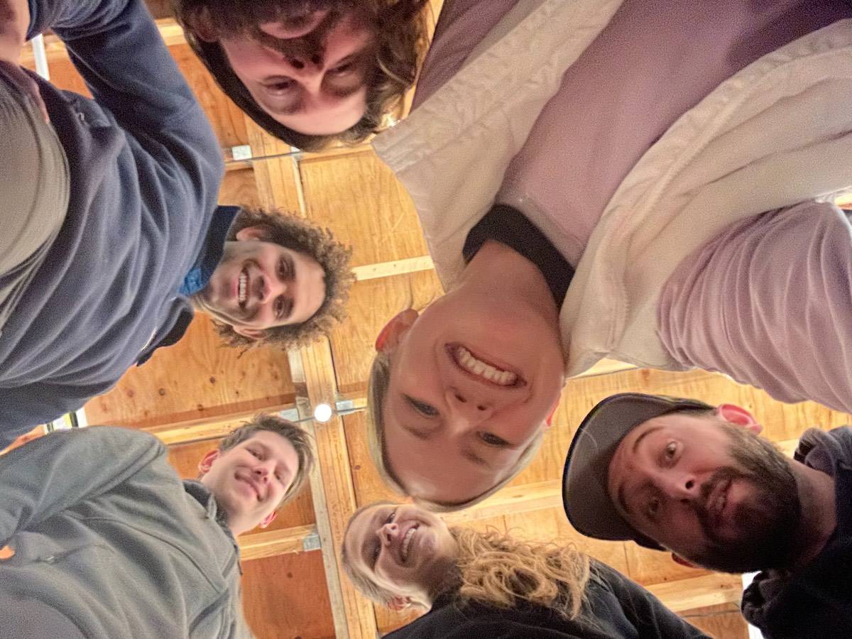 The band huddled together